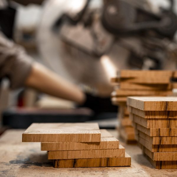 side-view-female-carpenter-studio-using-electric-saw-scaled
